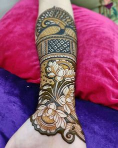 a woman's hand with henna tattoos on it