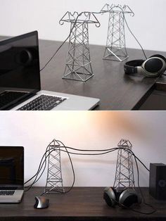 there are two pictures of electrical towers on the desk, one is made out of wire and the other has headphones attached to it