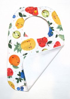 *Adorable smiling watermelon, pears, lemons, oranges, and berries on white background, *Full coverage bib made of cotton material lined with lightweight white canvas with decorative white top-stitching *Perfect baby/toddler gift *All fabrics are pre-washed and shrunk before assembly to prevent shrinking and bleeding *Materials:  Cotton with orange KAM snap *Fully washable in cold water and low tumble dry *Dimensions:  approximately 15" long, 10" wide, 8" from neck line to hem Please note:  Although we make every effort to provide you with the best image possible, please be aware that colors vary from one computer monitor to the next. Playful White Cotton Bib, Cute White Bib For Playtime, Cute Handmade White Bib, Cute White Handmade Bib, Toddler Gift, Best Image, White Canvas, Toddler Gifts, Top Stitching