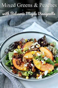 a white plate topped with salad and peaches