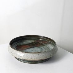 a bowl sitting on top of a white table