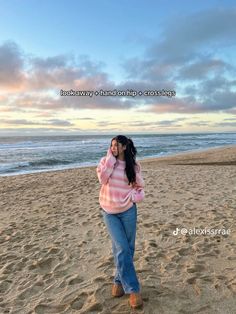 a woman standing on top of a sandy beach next to the ocean with a quote above her