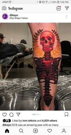 a man's leg with a skeleton tattoo on it