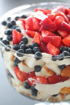 a trifle with strawberries and blueberries in it