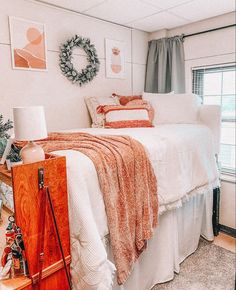 a bedroom with a bed, dresser and pictures hanging on the wall above it's headboard