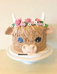 a cake decorated to look like a cow with horns and flowers on it's head