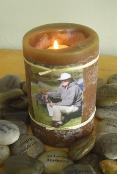 a candle sitting on top of a table next to rocks