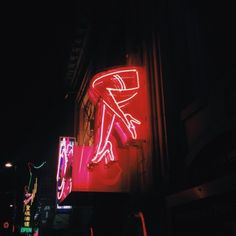 a neon sign that is on the side of a building