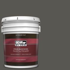 a green paint bucket with the label behr ultra stain and primer in one