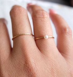 Simple and dainty tiny crystal pearl ring that's perfect for layering. The pearl is a round freshwater approximately 3mm. Pearls are always a classic and will never go out of style. The band is a gold-filled material and is non-tarnish. Wear it to sea, pool, spa, or just anywhere! Made in California Delicate Gold Stackable Pearl Ring, Delicate Stackable Pearl Ring For Anniversary, Everyday Pearl Open Ring, Adjustable Pearl Charm Rings For Everyday Wear, Delicate Stackable Pearl Ring For Everyday, Pearl Stackable Promise Rings, Stackable Pearl Promise Rings, Minimalist Pearl Rings With Pearl Charm, Delicate Tiny Midi Rings For Everyday