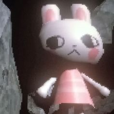 a pixelated image of an animal with pink cheeks and ears, standing in front of a black background