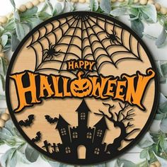 a wooden sign that says happy halloween with a castle and spider web in the center