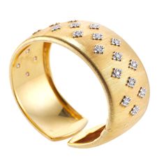 Classic 18k yellow gold cuff bracelet by Mario Buccellati, with approx. 1.00ctw VS-SI/H diamonds. DESIGNER: Buccellati MATERIAL: 18k Gold GEMSTONES: Diamond DIMENSIONS: Bracelet will fit approx. 6.5" wrist and is 1" wide. MARKED/TESTED: M. Buccellati, Italy, 750, Italian Buccellati mark. WEIGHT: 64.9 grams CONDITION: Previously owned excellent condition. Diamond Gold Bracelet, Yellow Gold Cuff Bracelet, Gold Cuff Bracelet, High Jewellery, Gold Bracelet Cuff, Gold Cuffs, Diamond Gold, Stunning Jewellery, High Jewelry