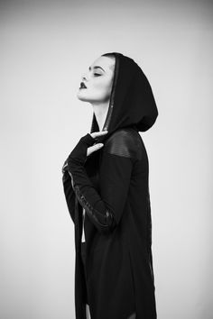 Long cotton lycra jacket designed with eco leather and lace on the back side. The model on the picture is wearing size S. Big hood, no zipper, no pockets, with thumbholes. Collection 'DISTRESSOR' Spring '21 Edgy Hooded Outerwear For Cosplay, Black Futuristic Hooded Jacket With Long Sleeves, Black Futuristic Long Sleeve Hooded Jacket, Futuristic Black Long Sleeve Hooded Jacket, Futuristic Black Hooded Jacket With Long Sleeves, Edgy Hooded Outerwear For Alternative Fashion, Edgy Hooded Outerwear For Alternative Style, Cyberpunk Hooded Jacket With Detachable Hood, Fitted Hooded Punk Outerwear