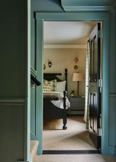 an open door leading to a bedroom with green walls