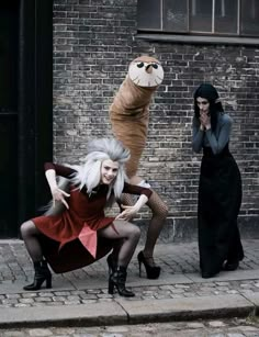 two women dressed as cats and one is wearing a cat costume while the other looks on