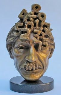 a bronze sculpture of a man's head with gears on his hair and beard