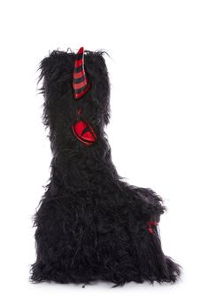 a black stuffed animal with red and black stripes on it's head, sitting in front of a white background