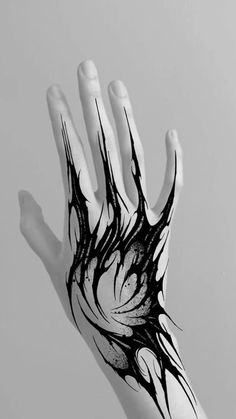 a person's hand with black and white ink on it, holding out their palm