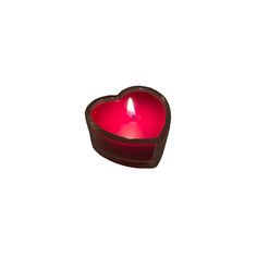 a heart shaped candle is lit on a white background