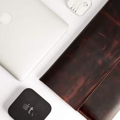 an apple laptop computer sitting on top of a desk next to a mouse and keyboard