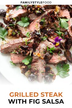 grilled steak with fig salsa is served on a white plate and garnished with fresh herbs