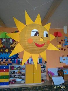 a sun decoration hanging from the ceiling in a child's room