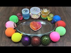 there are many different colored balls on the glass platter and around it is a heart shaped object