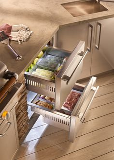 an open drawer in the middle of a kitchen