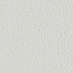 a white stucco wall textured with paint