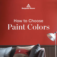 a red wall with the words how to choose paint colors on it and a couch