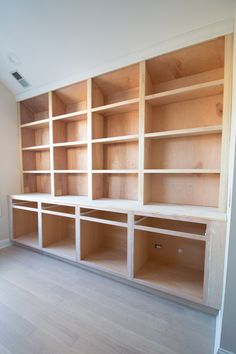 an empty room with wooden shelves in it