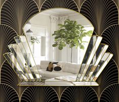 an art deco mirror in the shape of a living room with black and gold accents