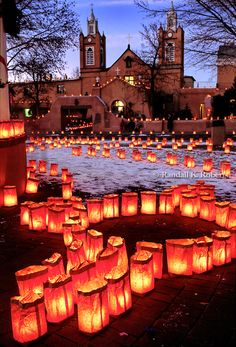 many lit up paper lanterns are on the ground