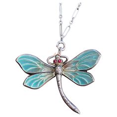 Details: Plique-a-Jour Art Nouveau dragonfly pendant necklace in sterling silver in beautiful shades of blue and green with little bright red eyes—possibly ruby or maybe paste, not tested. Plique-a-jour is an enamel process from the 15th century that allows light through the enameling, so they look like little pieces of stained glass. There is one hallmark on the backside that is stamped 935. You will not be disappointed! Please ask all necessary questions prior to placing an order! Size: The bu Silver Art Nouveau Necklace For Gift, Art Nouveau Jewelry Lalique, Handmade Art Nouveau Pendant Necklace, Dragonfly Necklace Novica, Art Nouveau Pendant With Vintage Charm, Dragonfly Pendant, Red Eyes, Butterfly Pendant, Silver Pendant Necklace