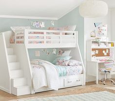 a child's bedroom with bunk beds, desk and stairs