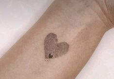 a fingerprint in the shape of a heart is shown on a person's arm