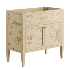 a white cabinet with gold paint on the doors and drawer handles, in front of a white background