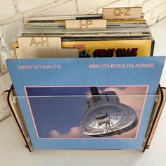 a stack of records sitting on top of a table