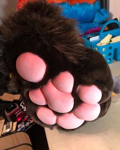 a close up of a stuffed animal paw on a table