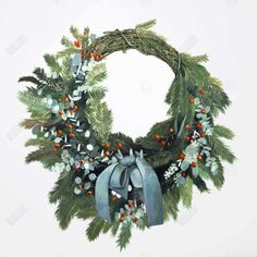 a christmas wreath with blue bows and berries