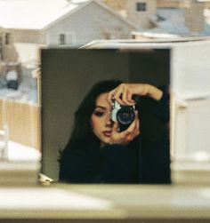 a woman taking a photo with her camera