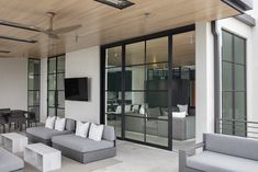 a living room filled with furniture and a flat screen tv mounted to the side of a wall