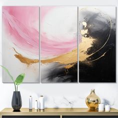 three abstract paintings on a wall in a living room