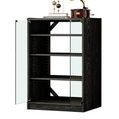 a bookcase with glass doors and an antique clock on it's top shelf