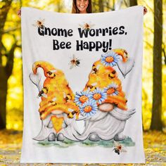 a woman holding up a towel that says, gnome worries bee happy