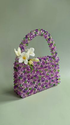 a purple purse with flowers in it