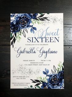 an elegant blue and white floral wedding suite is displayed on a wooden table with the text sweet sixteen