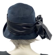 The Eleanor cloche is the quintessence of the 1920s and '30s. Think of Downton Abbey, Peaky Blinders, and Boardwalk Empire with the modern-day chic of the 2020s!This lovely handmade hat has a shaped crown and a wide front brim that can be worn tipped up in varying degrees to change the look. This style sits low down on the head and is sure to keep out the chill in the air, helping you stay warm and super stylish too.This Eleanor is handmade in a luxurious black velvet. Trimmed with a satin scarf Fitted Flapper Cloche Hat With Brim, Fitted Cloche Hat For Evening In Spring, Winter Gatsby Style Fitted Cloche Hat, Spring Evening Fitted Cloche Hat, Fitted Cloche Hat With Flat Brim For Church, Classic Cloche Top Hat, Fitted Cloche Hat For Winter Evenings, Fitted Cloche Hat For Evening In Winter, Fitted Black Cloche Hat