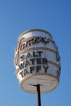 an old fashioned water tower with the name james's salt water taffy on it